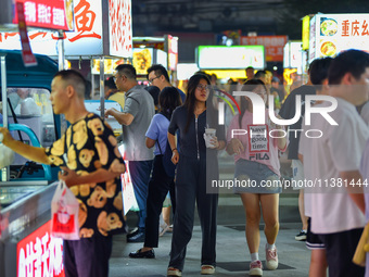 Citizens are enjoying food and leisure time at a night market in Nanjing, China, on July 3, 2024. (