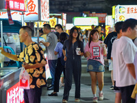 Citizens are enjoying food and leisure time at a night market in Nanjing, China, on July 3, 2024. (