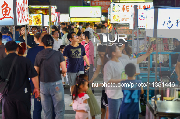 Citizens are enjoying food and leisure time at a night market in Nanjing, China, on July 3, 2024. 