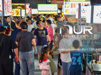 Citizens are enjoying food and leisure time at a night market in Nanjing, China, on July 3, 2024. (