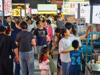 Citizens are enjoying food and leisure time at a night market in Nanjing, China, on July 3, 2024. (