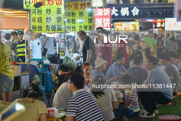 Citizens are enjoying food and leisure time at a night market in Nanjing, China, on July 3, 2024. 