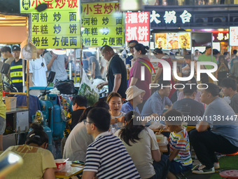 Citizens are enjoying food and leisure time at a night market in Nanjing, China, on July 3, 2024. (