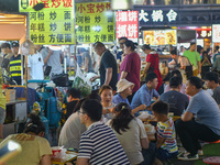 Citizens are enjoying food and leisure time at a night market in Nanjing, China, on July 3, 2024. (