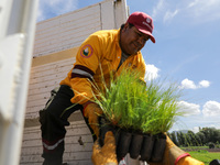 Workers of the Heroic Brigade Corps are holding different varieties of plants that will be planted during the ''Green Challenge 2024,'' with...