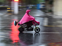 A citizen is riding in a rainstorm in Fuyang, China, on July 4, 2024. On the same day, Fuyang city in Anhui province is suffering heavy rain...