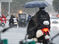 A citizen is riding in a rainstorm in Fuyang, China, on July 4, 2024. On the same day, Fuyang city in Anhui province is suffering heavy rain...