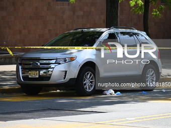 A vehicle is being damaged as a result of the shooting at the crime scene. Two people are being shot in Paterson, New Jersey, United States,...