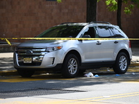 A vehicle is being damaged as a result of the shooting at the crime scene. Two people are being shot in Paterson, New Jersey, United States,...