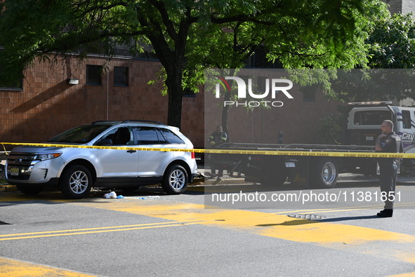 A vehicle is being damaged as a result of the shooting at the crime scene. Two people are being shot in Paterson, New Jersey, United States,...