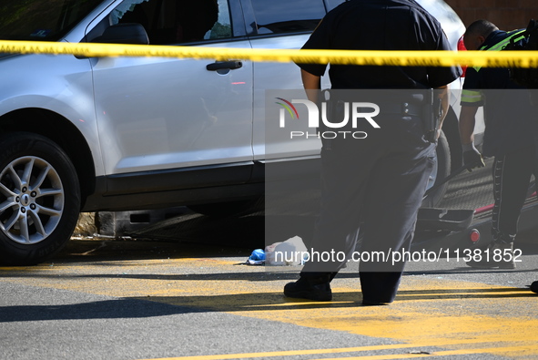 A vehicle is being damaged as a result of the shooting at the crime scene. Two people are being shot in Paterson, New Jersey, United States,...