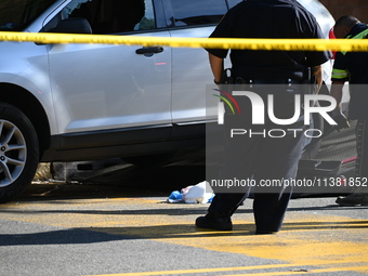 A vehicle is being damaged as a result of the shooting at the crime scene. Two people are being shot in Paterson, New Jersey, United States,...