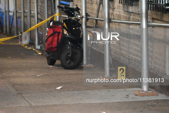 Evidence markers are being placed at the crime scene by the New York City Police Department Crime Scene Unit. One person is being assaulted,...