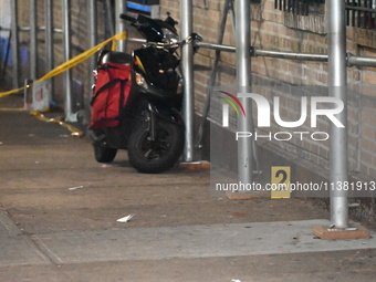 Evidence markers are being placed at the crime scene by the New York City Police Department Crime Scene Unit. One person is being assaulted,...