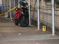 Evidence markers are being placed at the crime scene by the New York City Police Department Crime Scene Unit. One person is being assaulted,...