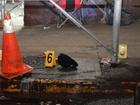 Evidence markers are being placed at the crime scene by the New York City Police Department Crime Scene Unit. One person is being assaulted,...