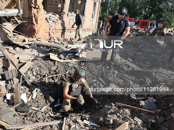 Law enforcers are examining the crater from an impact in a residential area after the Russian glide bomb attack in Kharkiv, Ukraine, on July...