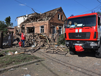 A Ukrainian Red Cross Society representative is standing outside a house destroyed by the Russian glide bomb attack in Kharkiv, Ukraine, on...