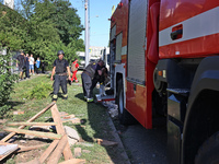 Rescuers are staying by a fire engine in a residential area after the Russian glide bomb attack in Kharkiv, Ukraine, on July 3, 2024. At abo...