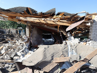 A crashed car is being seen in a destroyed garage in a residential area after the Russian glide bomb attack in Kharkiv, Ukraine, on July 3,...