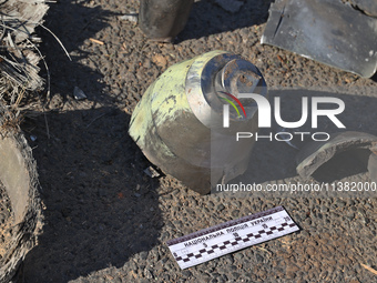 Fragments of a Russian projectile are being collected in a residential area after the Russian glide bomb attack in Kharkiv, Ukraine, on July...