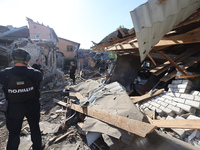 Police officers are examining buildings in a residential area destroyed by the Russian glide bomb attack in Kharkiv, Ukraine, on July 3, 202...