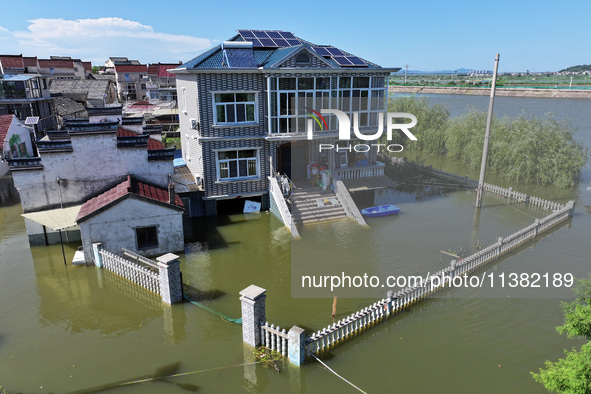 The water level of Shijiu Lake is rising after days of rainstorm, and some surrounding villages are flooding in Nanjing, China, on July 4, 2...