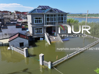 The water level of Shijiu Lake is rising after days of rainstorm, and some surrounding villages are flooding in Nanjing, China, on July 4, 2...