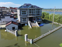 The water level of Shijiu Lake is rising after days of rainstorm, and some surrounding villages are flooding in Nanjing, China, on July 4, 2...