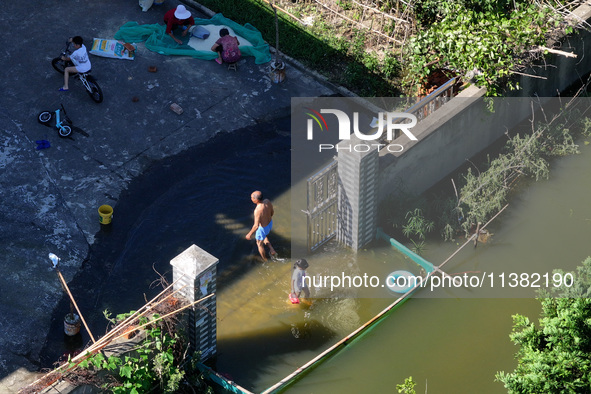 The water level of Shijiu Lake is rising after days of rainstorm, and some surrounding villages are flooding in Nanjing, China, on July 4, 2...