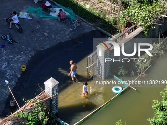 The water level of Shijiu Lake is rising after days of rainstorm, and some surrounding villages are flooding in Nanjing, China, on July 4, 2...