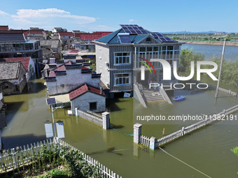 The water level of Shijiu Lake is rising after days of rainstorm, and some surrounding villages are flooding in Nanjing, China, on July 4, 2...