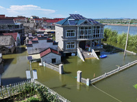 The water level of Shijiu Lake is rising after days of rainstorm, and some surrounding villages are flooding in Nanjing, China, on July 4, 2...