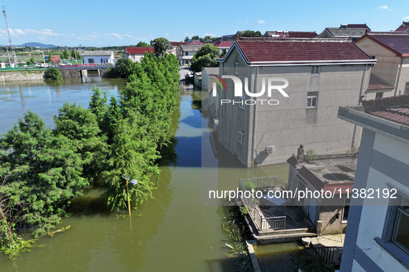 The water level of Shijiu Lake is rising after days of rainstorm, and some surrounding villages are flooding in Nanjing, China, on July 4, 2...