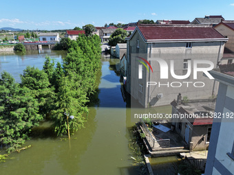 The water level of Shijiu Lake is rising after days of rainstorm, and some surrounding villages are flooding in Nanjing, China, on July 4, 2...