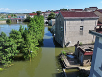 The water level of Shijiu Lake is rising after days of rainstorm, and some surrounding villages are flooding in Nanjing, China, on July 4, 2...