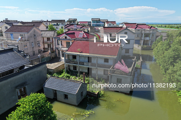 The water level of Shijiu Lake is rising after days of rainstorm, and some surrounding villages are flooding in Nanjing, China, on July 4, 2...