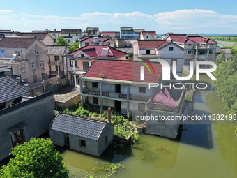 The water level of Shijiu Lake is rising after days of rainstorm, and some surrounding villages are flooding in Nanjing, China, on July 4, 2...