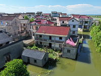 The water level of Shijiu Lake is rising after days of rainstorm, and some surrounding villages are flooding in Nanjing, China, on July 4, 2...