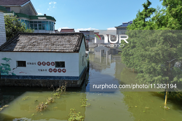 The water level of Shijiu Lake is rising after days of rainstorm, and some surrounding villages are flooding in Nanjing, China, on July 4, 2...