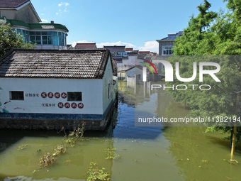 The water level of Shijiu Lake is rising after days of rainstorm, and some surrounding villages are flooding in Nanjing, China, on July 4, 2...