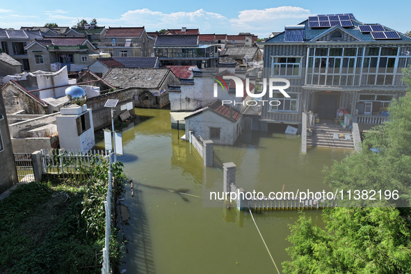 The water level of Shijiu Lake is rising after days of rainstorm, and some surrounding villages are flooding in Nanjing, China, on July 4, 2...