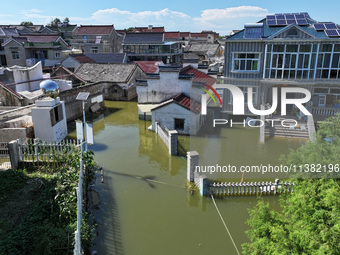 The water level of Shijiu Lake is rising after days of rainstorm, and some surrounding villages are flooding in Nanjing, China, on July 4, 2...