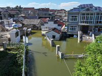 The water level of Shijiu Lake is rising after days of rainstorm, and some surrounding villages are flooding in Nanjing, China, on July 4, 2...