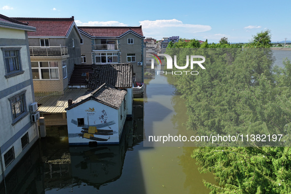 The water level of Shijiu Lake is rising after days of rainstorm, and some surrounding villages are flooding in Nanjing, China, on July 4, 2...