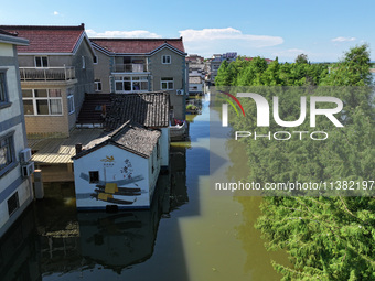 The water level of Shijiu Lake is rising after days of rainstorm, and some surrounding villages are flooding in Nanjing, China, on July 4, 2...