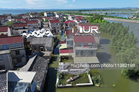 The water level of Shijiu Lake is rising after days of rainstorm, and some surrounding villages are flooding in Nanjing, China, on July 4, 2...