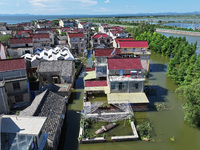 The water level of Shijiu Lake is rising after days of rainstorm, and some surrounding villages are flooding in Nanjing, China, on July 4, 2...