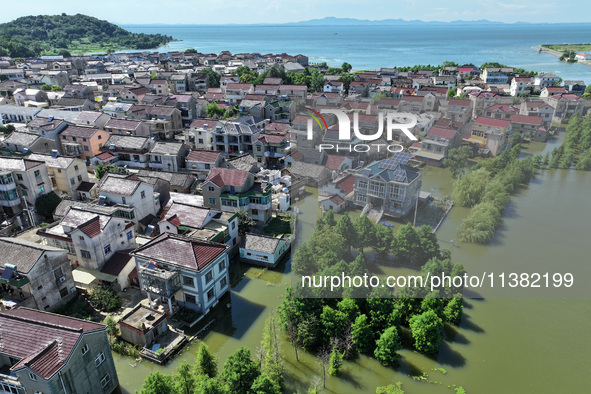 The water level of Shijiu Lake is rising after days of rainstorm, and some surrounding villages are flooding in Nanjing, China, on July 4, 2...