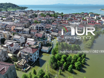 The water level of Shijiu Lake is rising after days of rainstorm, and some surrounding villages are flooding in Nanjing, China, on July 4, 2...